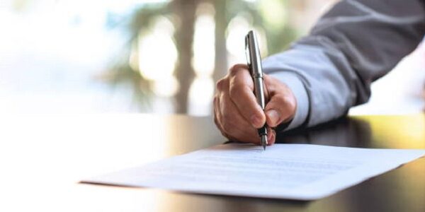 Businessman Signing An Official Document